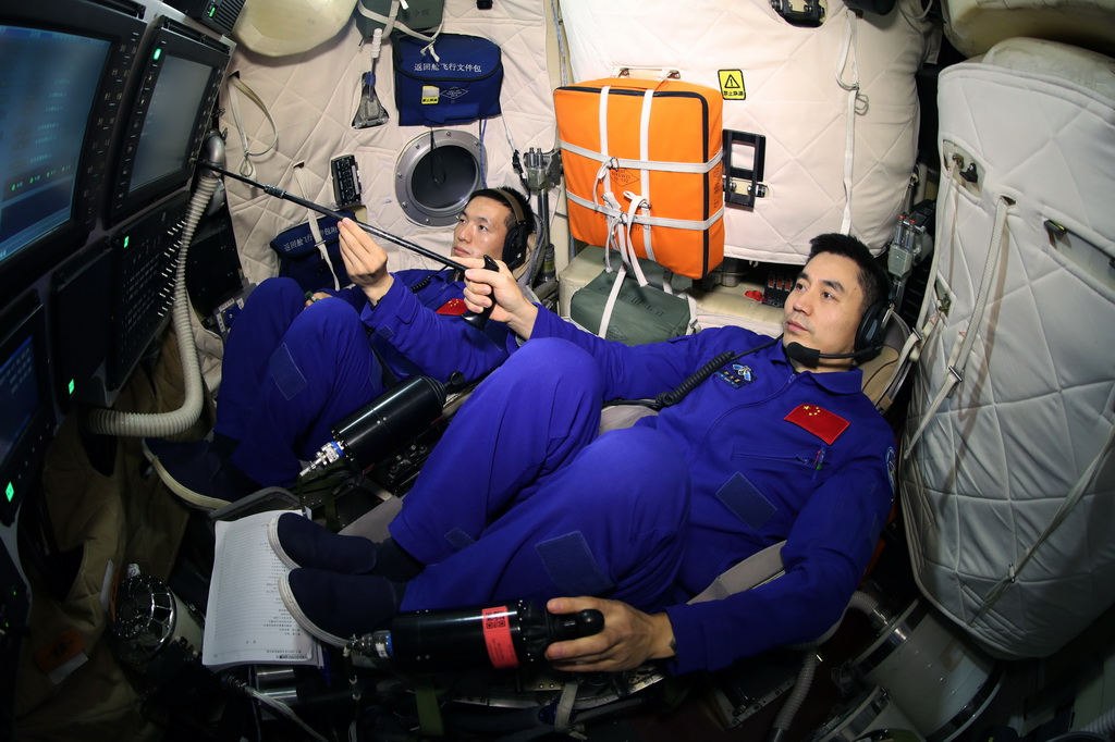 2023年12月7日，神舟十八号航天员叶光富（右）和李聪在进行飞船模拟器训练。新华社发（徐部 摄）